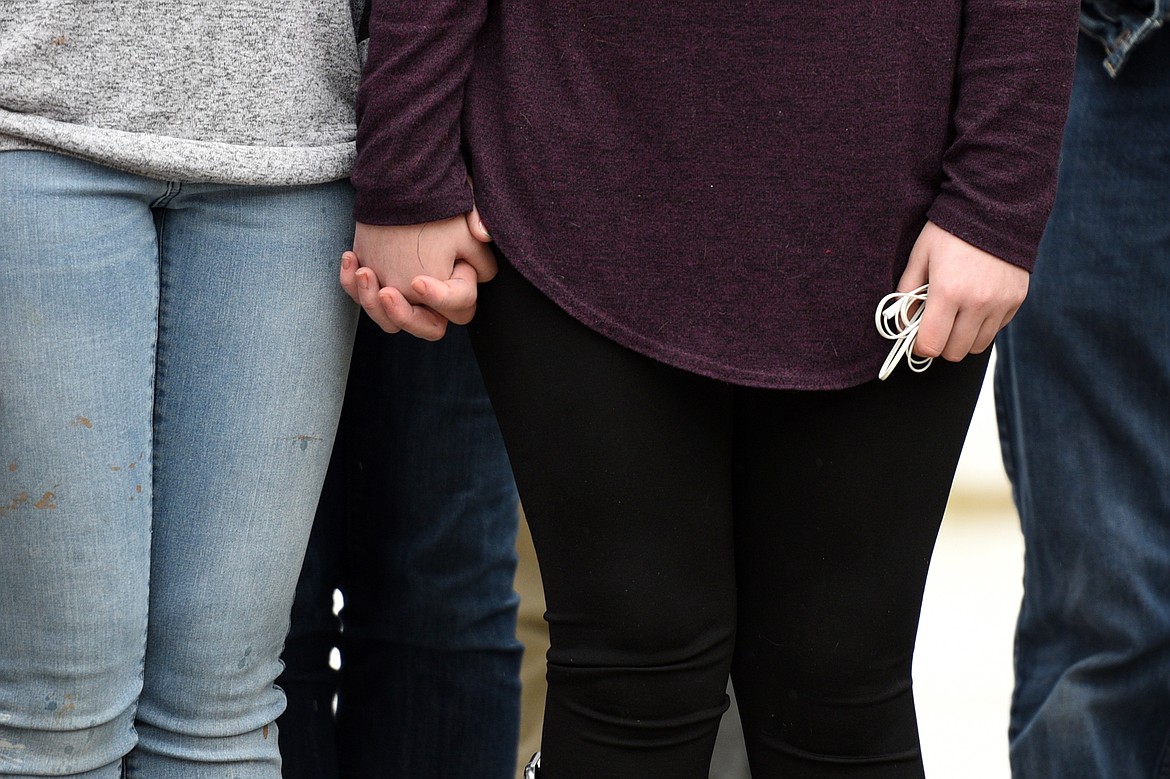 Flathead High School students participate in the student-planned &quot;17 Minutes of Silence Memorial&quot; Wednesday afternoon to mark one month since a mass shooting left 17 dead at Marjory Stoneman Douglas High School in Parkland, Fla. (Casey Kreider/Daily Inter Lake)