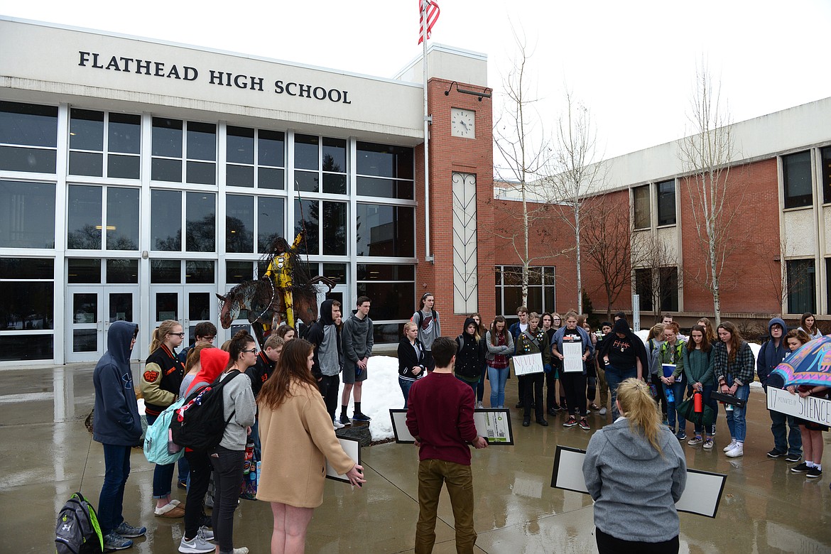 Flathead High School students participate in the student-planned &quot;17 Minutes of Silence Memorial&quot; Wednesday afternoon to mark one month since a mass shooting left 17 dead at Marjory Stoneman Douglas High School in Parkland, Fla. (Casey Kreider/Daily Inter Lake)