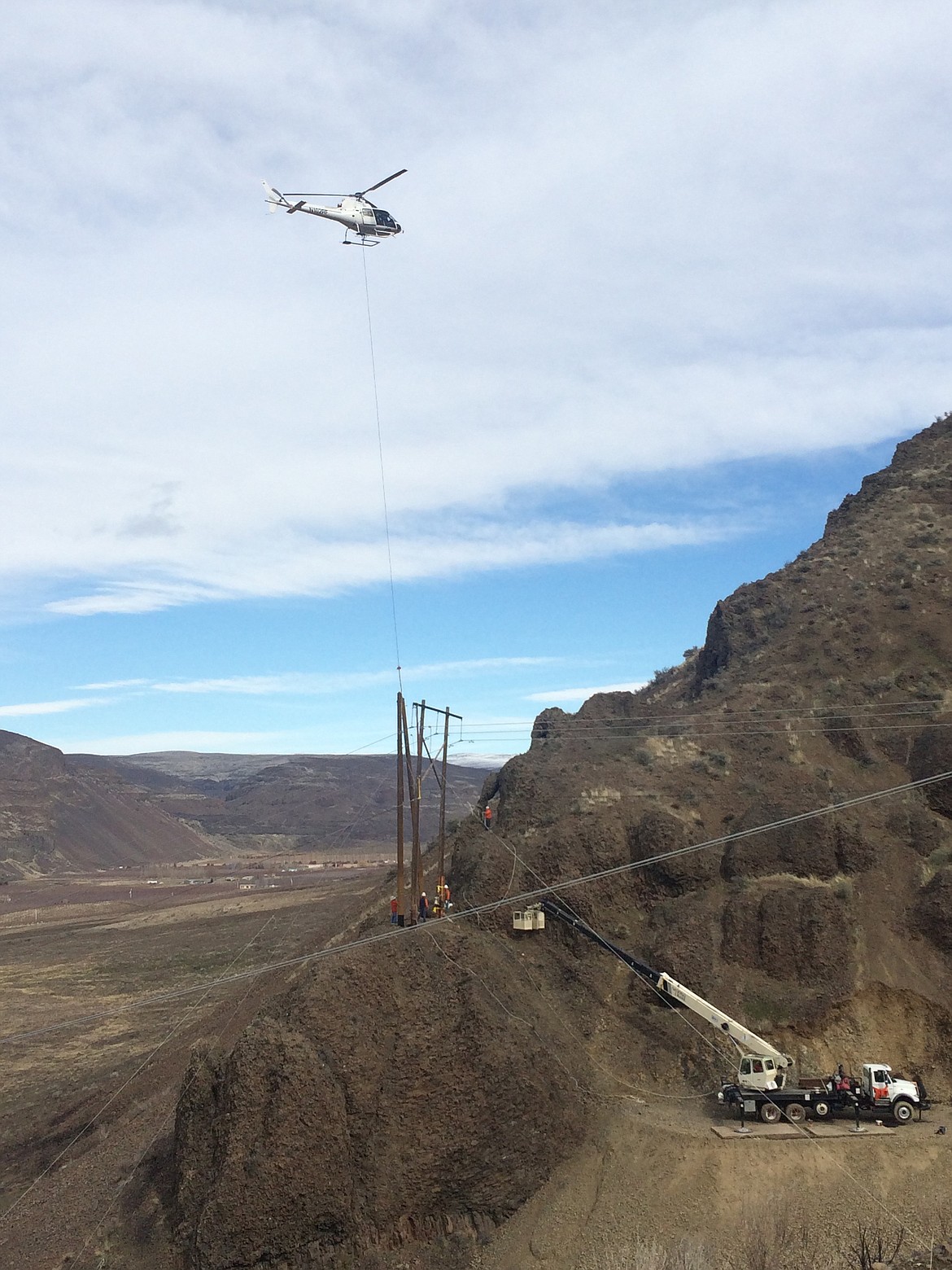 Grant PUD/courtesy photo
Grant County PUD crews were required to use a helicopter to replace a power pole damaged by fire last summer but not spotted until February.