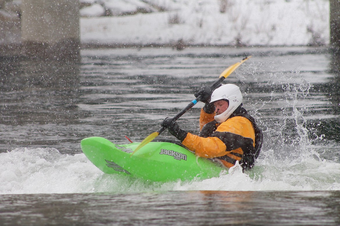 Darren Kellogg rides the rapids on the Spokane River.