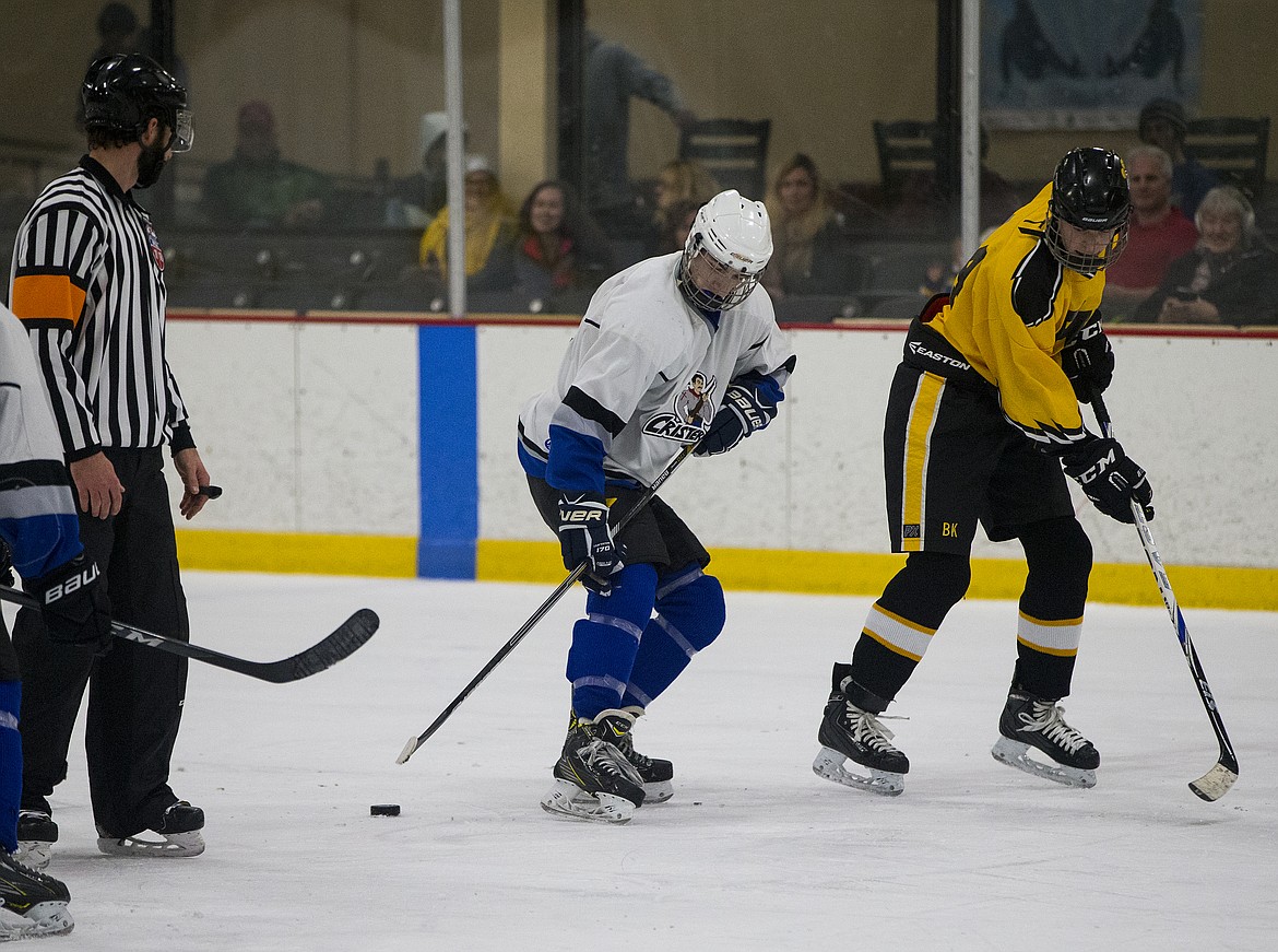 Matt Hoffman, with the Cristeros hockey team, gains possession of the puck at center ice in a game against the Boise Knights.