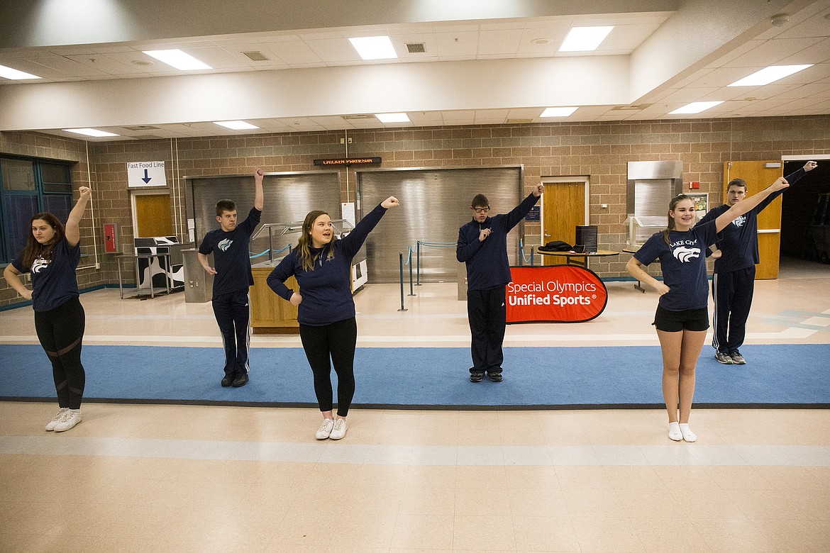 Lake City cheerleaders Maddianna Morrow, front left, Shelby Beaton, center, and Jessica Gilmore, front right, help lead Jim Kinnard, Kole Teague and Jake Ragsdale through a cheer during All Abilities Cheer practice Thursday evening at Lake City High School. (LOREN BENOIT/Press)