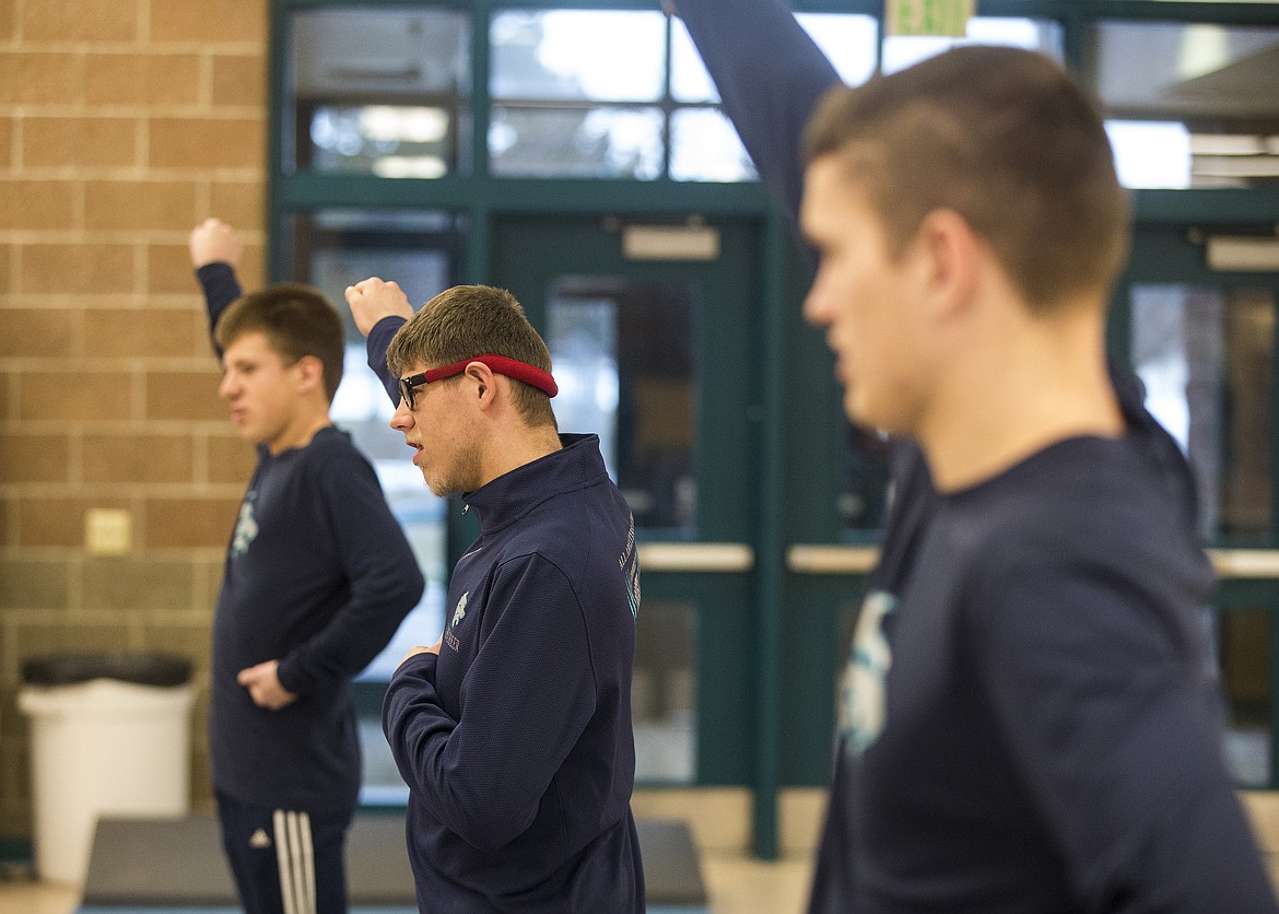 From left, Jim Kinnard, Kole Teague and Jake Ragsdale practice a cheer during an All Abilities Cheer practice on Thursday at Lake City High School. (LOREN BENOIT/Press)