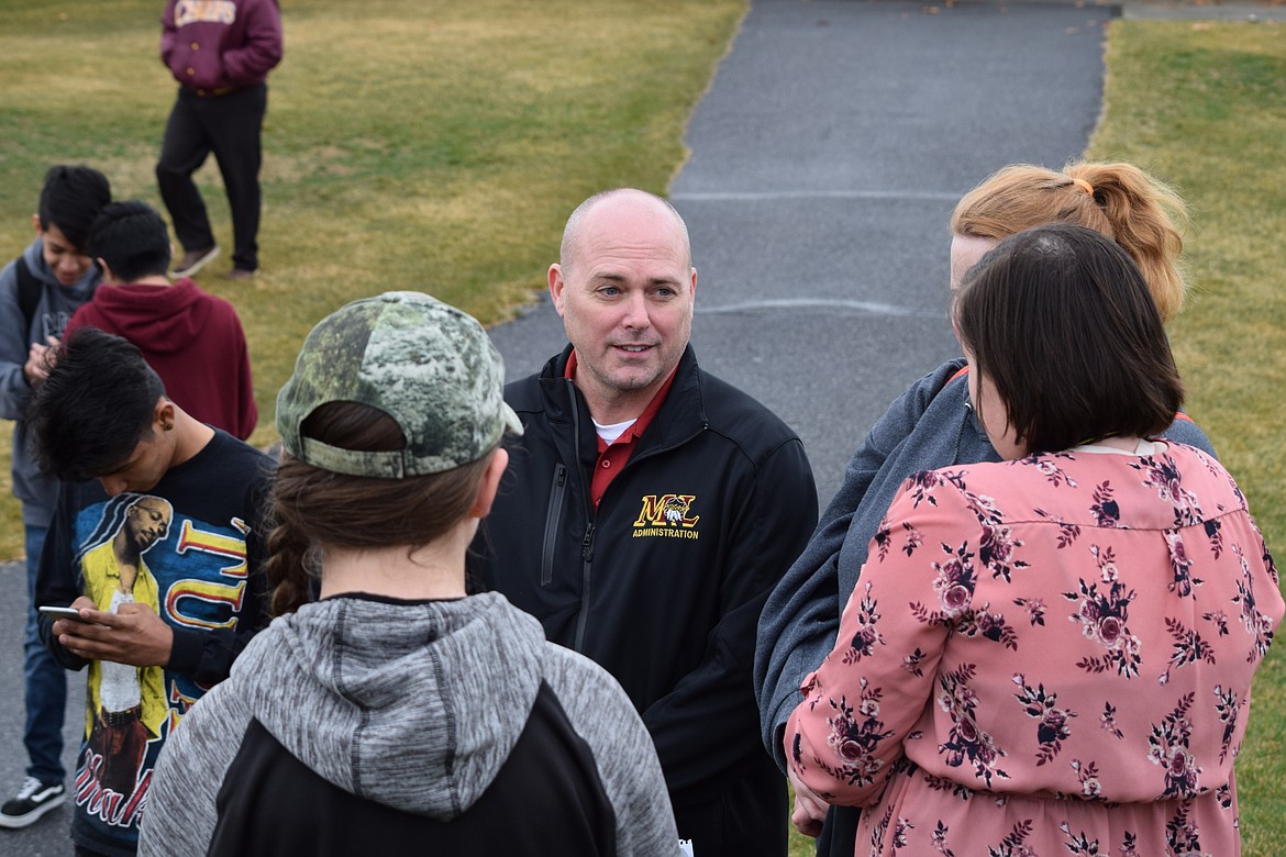 Charles H. Featherstone/Columbia Basin Herald
Principal Jake Long talks with students Wednesday morning during the walkout against school violence at Moses Lake High School.