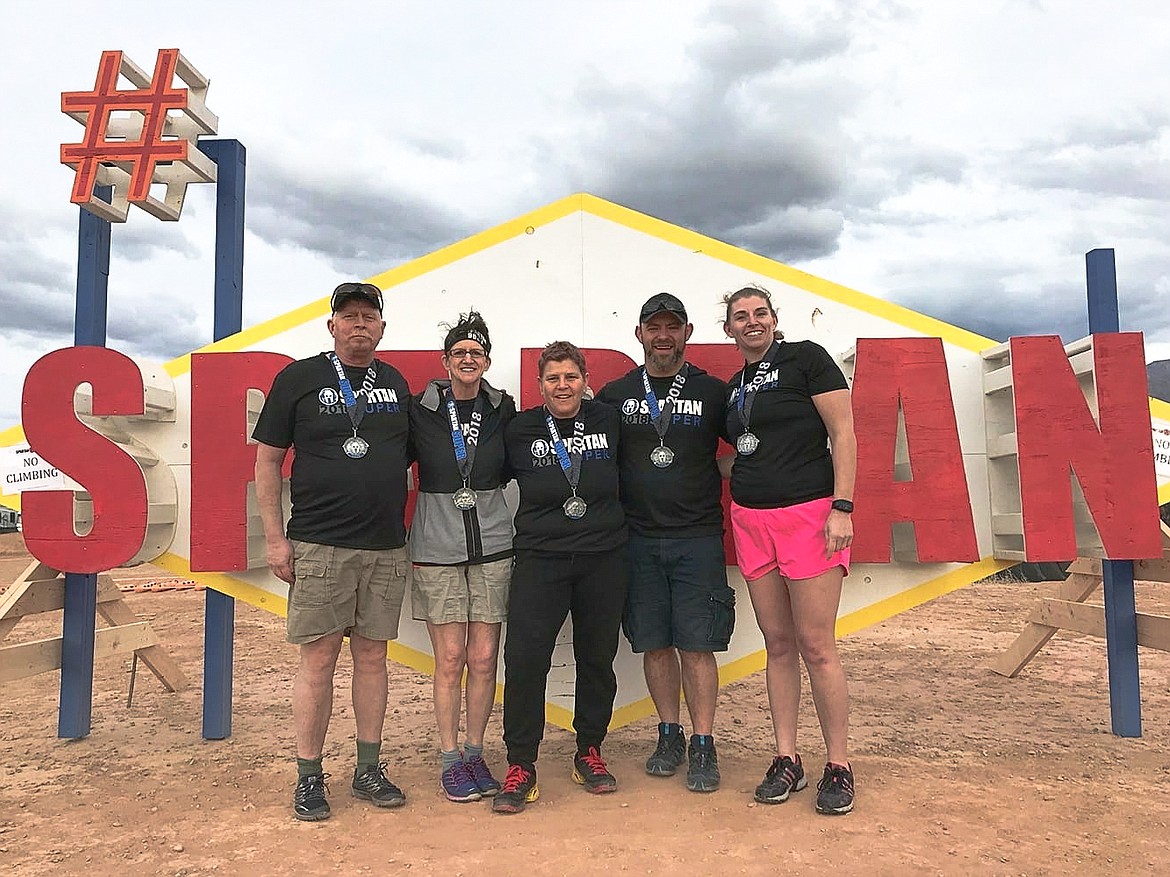 Kelly and Suzie Garcia, Roxanna Escuerdo, and Tim and Lindsay Beaty pose with their medals after completing a 8.4 mile course. (Courtesy photo)