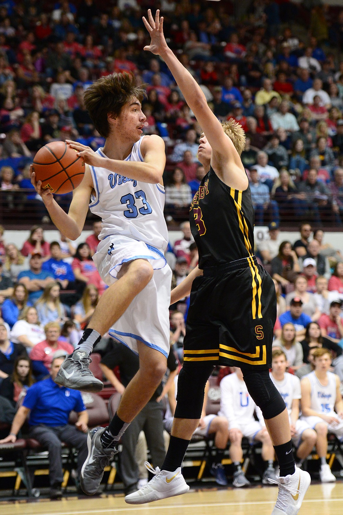 Bigfork's Beau Santistevan looks to pass around Shelby defender TJ Reynolds during a 60-56 win in the championship of the 2018 State Class B Boys' Basketball Tournament at Dahlberg Arena in Missoula on Saturday, March 10. (Casey Kreider/Daily Inter Lake)