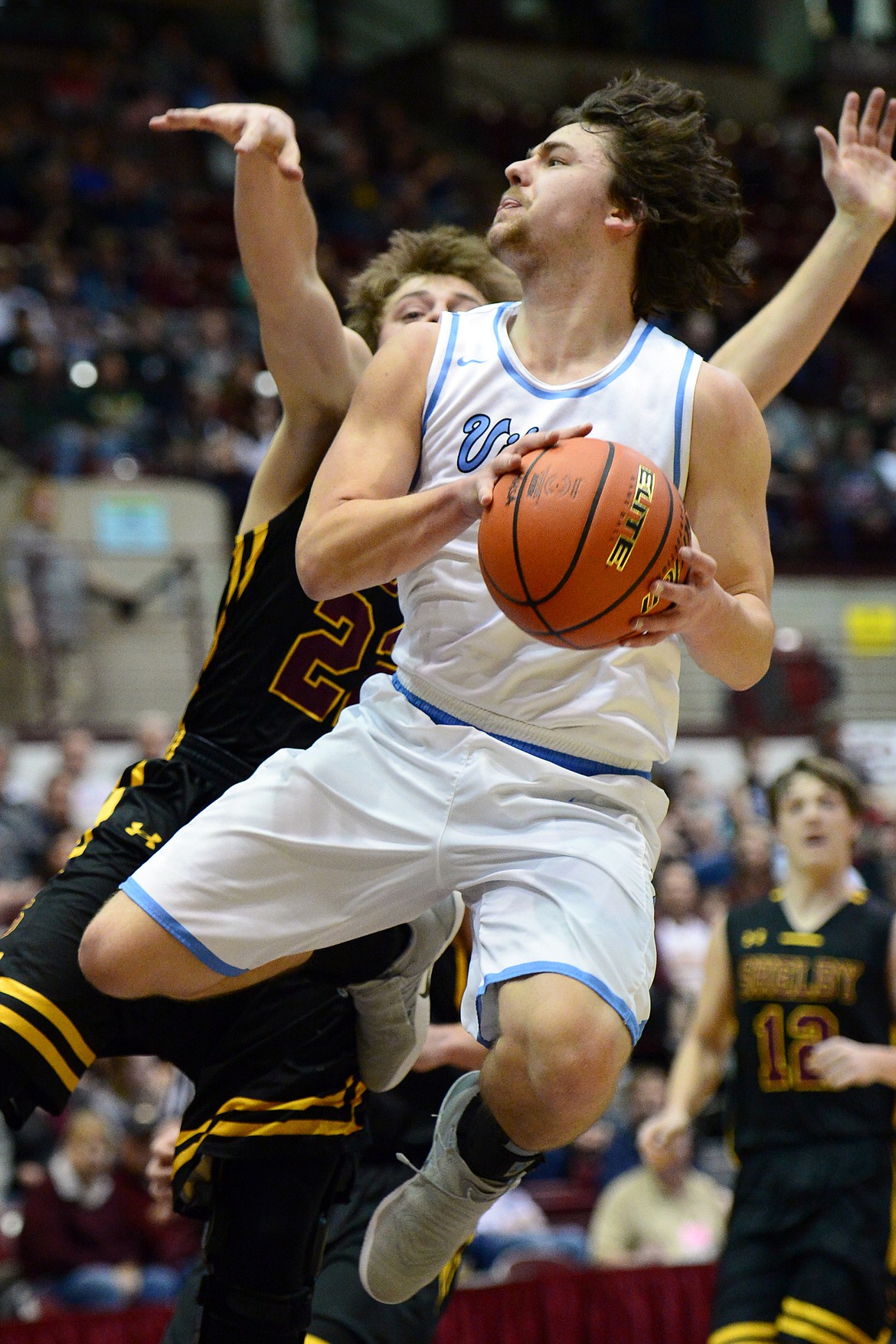 Bigfork's Anders Epperly drives to the basket against Shelby defender Logan Watson during a 60-56 win in the championship of the 2018 State Class B Boys' Basketball Tournament at Dahlberg Arena in Missoula on Saturday, March 10. (Casey Kreider/Daily Inter Lake)