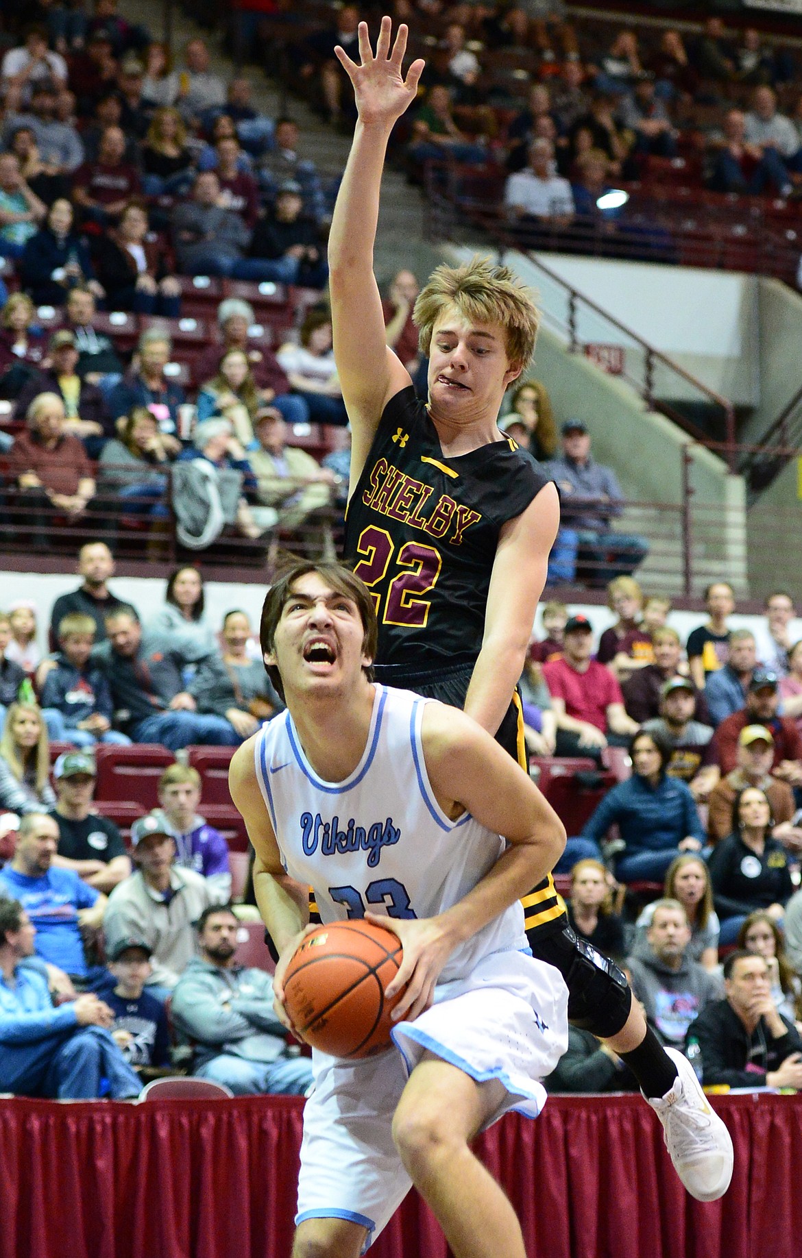 Bigfork's Beau Santistevan is fouled by Shelby's Logan Watson during a 60-56 win in the championship of the 2018 State Class B Boys' Basketball Tournament at Dahlberg Arena in Missoula on Saturday, March 10. (Casey Kreider/Daily Inter Lake)