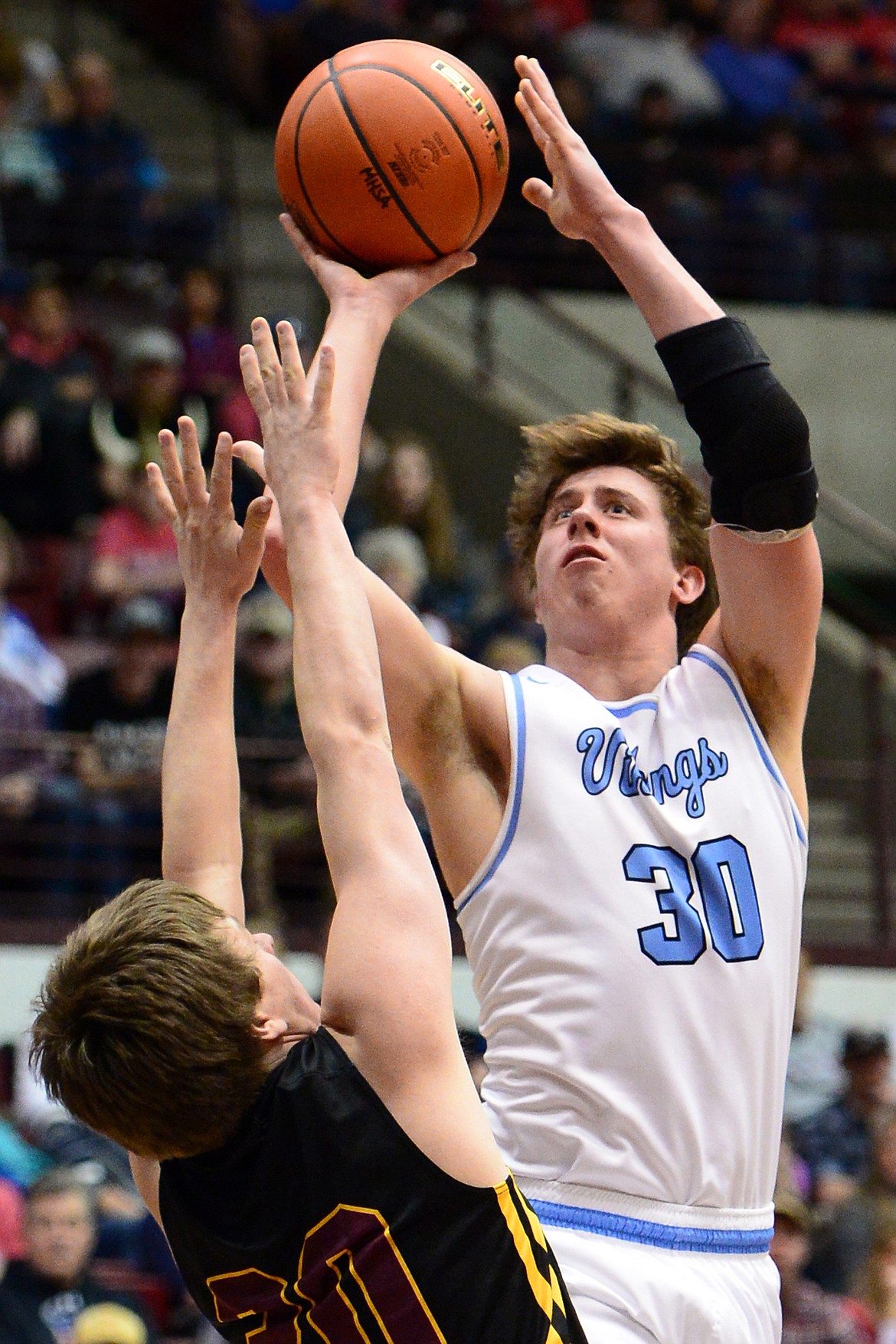 Bigfork's Logan Gilliard shoots over Shelby defender Logan Leck during a 60-56 championship victory in the 2018 State Class B Boys' Basketball Tournament at Dahlberg Arena in Missoula on Saturday, March 10. (Casey Kreider/Daily Inter Lake)