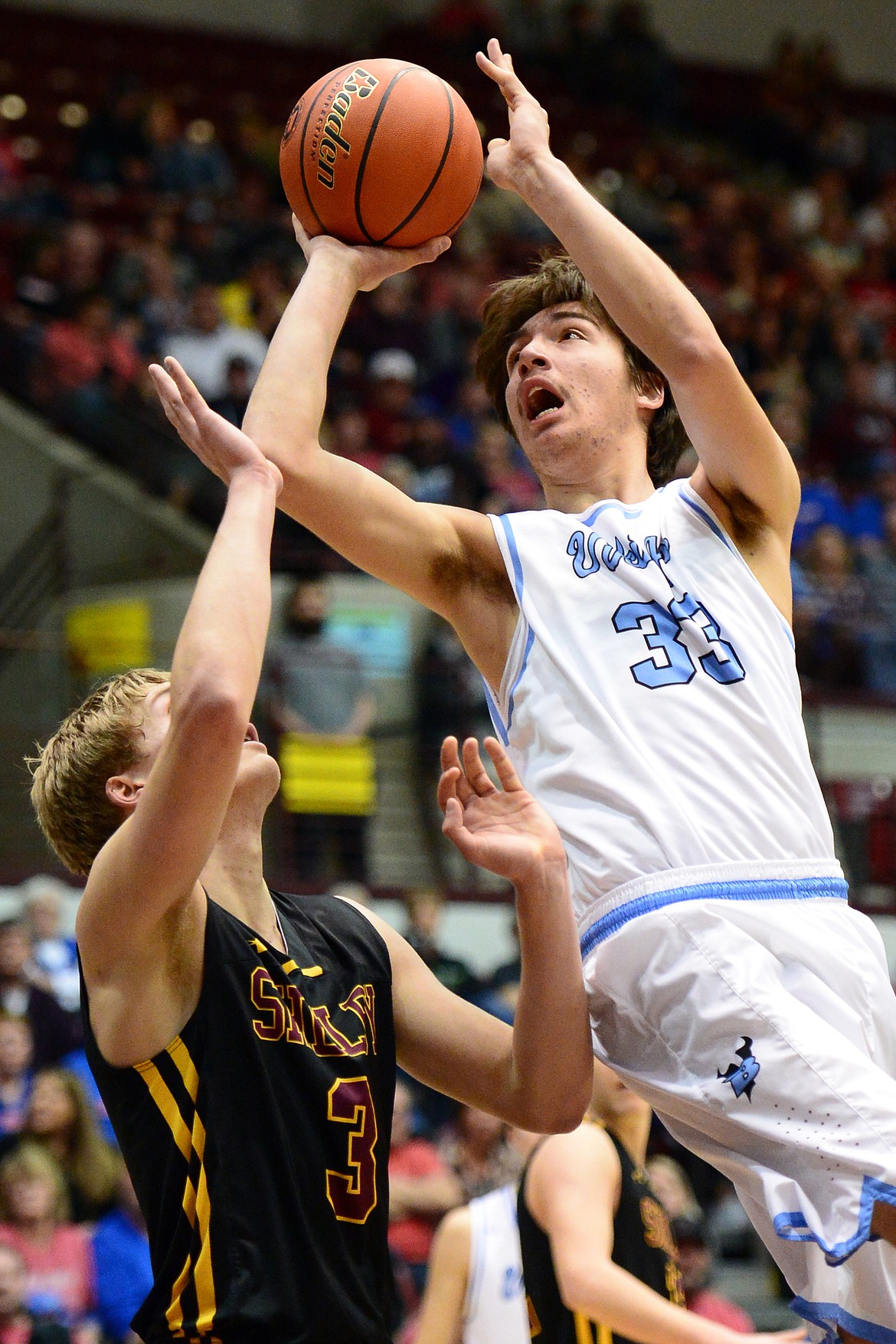 Bigfork's Beau Santistevan pours in two points over Shelby defender TJ Reynolds during a 60-56 win in the championship of the 2018 State Class B Boys' Basketball Tournament at Dahlberg Arena in Missoula on Saturday, March 10. (Casey Kreider/Daily Inter Lake)