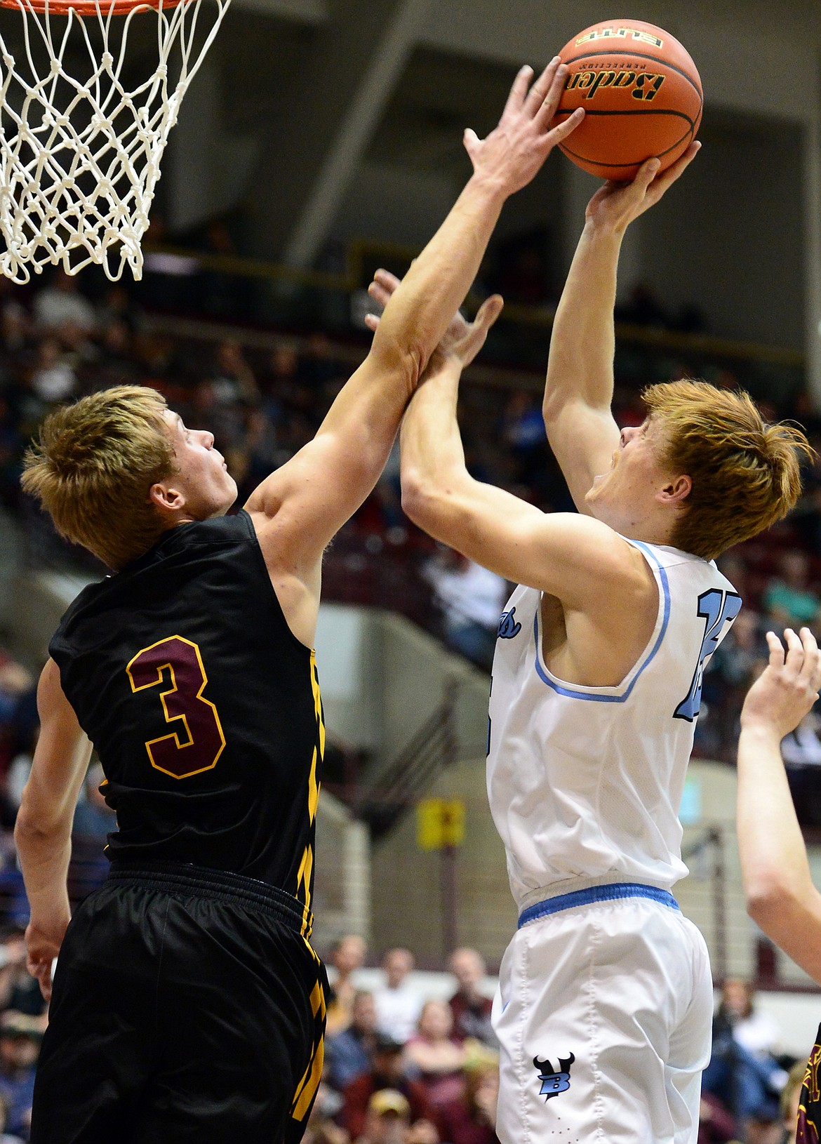 Bigfork's Logan Taylor has his shot blocked by Shelby's TJ Reynolds during the championship game of the 2018 State Class B Boys' Basketball Tournament at Dahlberg Arena in Missoula on Saturday, March 10. (Casey Kreider/Daily Inter Lake)