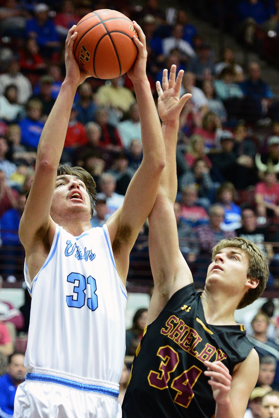 Bigfork's Beau Santistevan pours in two points over Shelby defender Macager McAllister during a 60-56 win in the championship of the 2018 State Class B Boys' Basketball Tournament at Dahlberg Arena in Missoula on Saturday, March 10. (Casey Kreider/Daily Inter Lake)