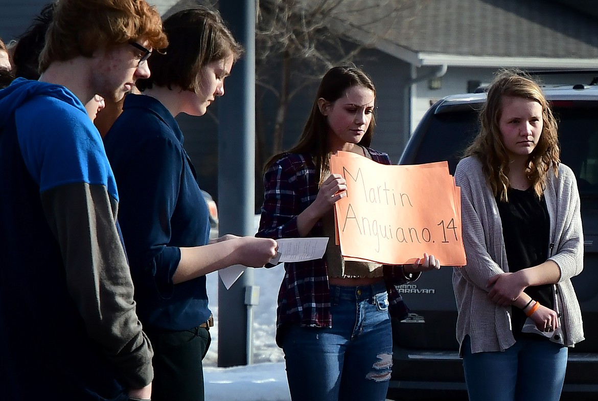 Columbia Falls senior Kathleen Foley-Helton reads off the names and ages of those killed in February&#146;s Marjory Stoneman Douglas High School shooting in Florida. The reading of each name was followed by a minute of silence. (Jeremy Weber photo)