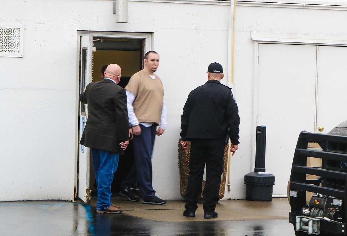 Photo by Mandi Bateman
Eric Dante is escorted from the courthouse on March 8.