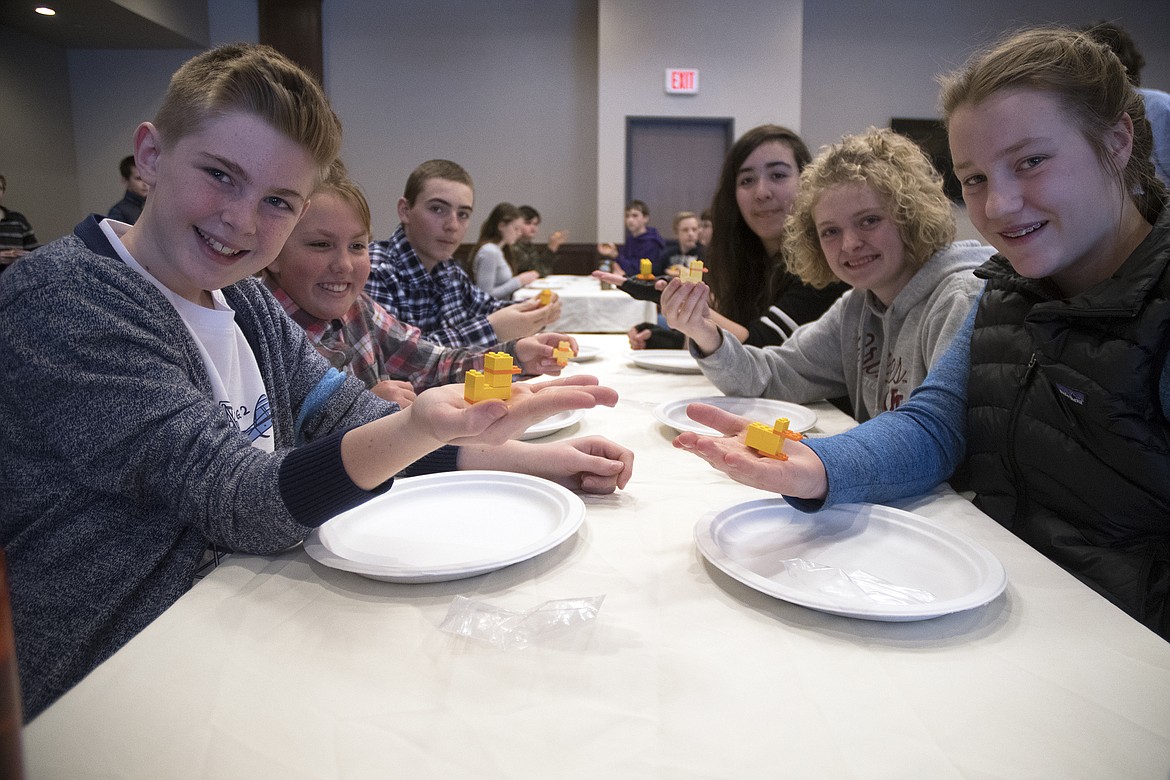 Middle school students Quinn Clark, Paeden Matson, Bradley Fields, Emma Rae Pehoni, Demye Rensel and Haden E. Peters show off their ducks during a Lego learning event at Cedar Creek Lodge Thursday. (Jeremy Weber photo)