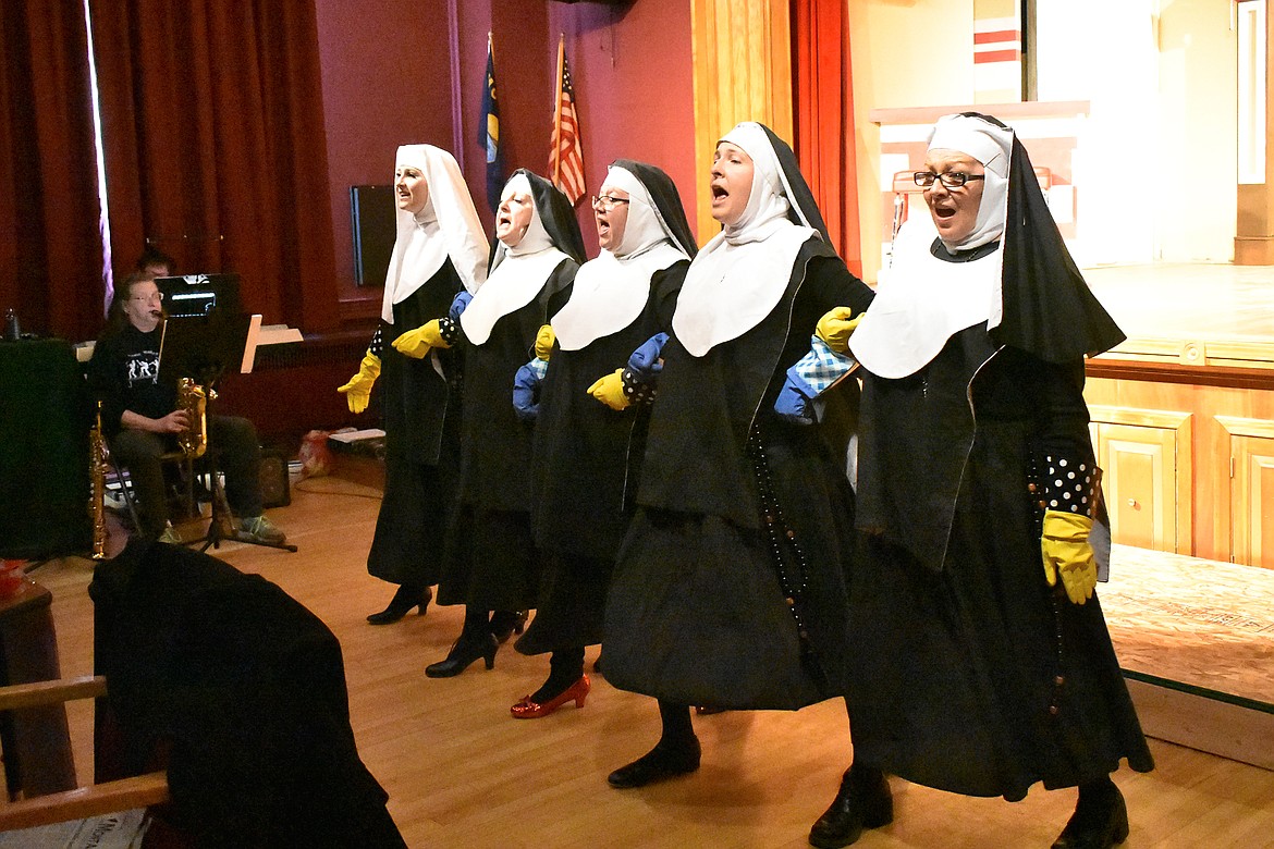 The nuns sing about the New Jersey state board of health and needing to defrost their deceased fellow sisters during a March 10 rehearsal of &#147;Nunsense&#148;. Pictured are Kootenai Karacters Saryn &#147;Sister Mary Leo&#148; Wilkinson, Molly &#147;Sister Mary Hubert&#148; Matthews-Woodruff, Sindy &#147;Sister Robert Anne&#148; Filler, Ashley &#147;Sister Mary Amnesia&#148; Day and Cynthia &#147;Sister Mary Regina&#148; Curtiss. In the background are Karen Disney on the saxophone and JoAnn Dolezal-Armstrong on the keyboard. (Ben Kibbey/The Western News)