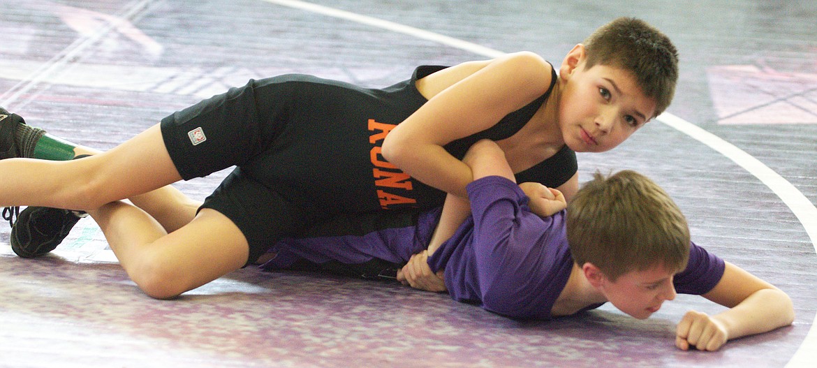 RONAN LITTLE GUY wrestler Gabe Brown attempts to pin his opponent in the Unit-2 qualifier Saturday afternoon at Polson High School. (Jason Blasco/Lake County Leader)