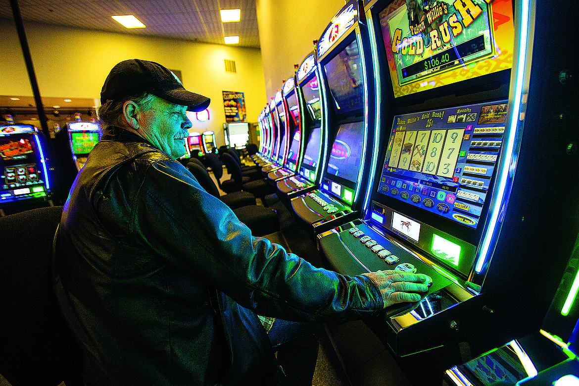 TESS FREEMAN/Press file
Mike Loberg plays Yukon Willie's gold rush, a historical horse racing instant gaming machine at the Greyhound Park and Event Center in Post Falls in December 2014. The Greyhound Park and Event center had acquired 35 instant gaming machines for their facility.