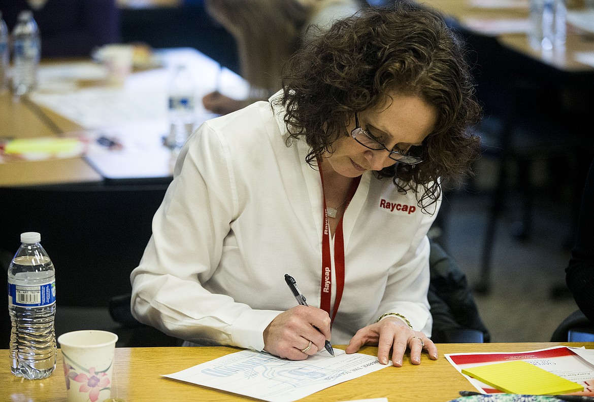LOREN BENOIT/NIBJ
Colleen Krajack with Raycap writes workplace improvements on a worksheet during a training and recruiting workshop at the Idaho Department of Labor.