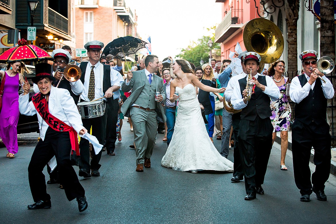 Photo by JEROME POLLOS PHOTOGRAPHY
Veronica and Chad Boenigk celebrate with friends, family, random tourist and a second band as they make their way through the French Quarter following their Friday, May 16, 2014, wedding in New Orleans.
