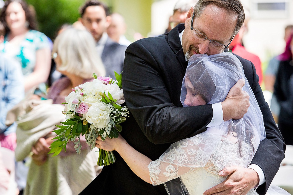 Photos by JEROME POLLOS PHOTOGRAPHY
Scott Linenberger embraces his daughter, Amber Linenberger, after walking her down the aisle on her wedding day Saturday, June 10, 2017, in Ontario, Ore.