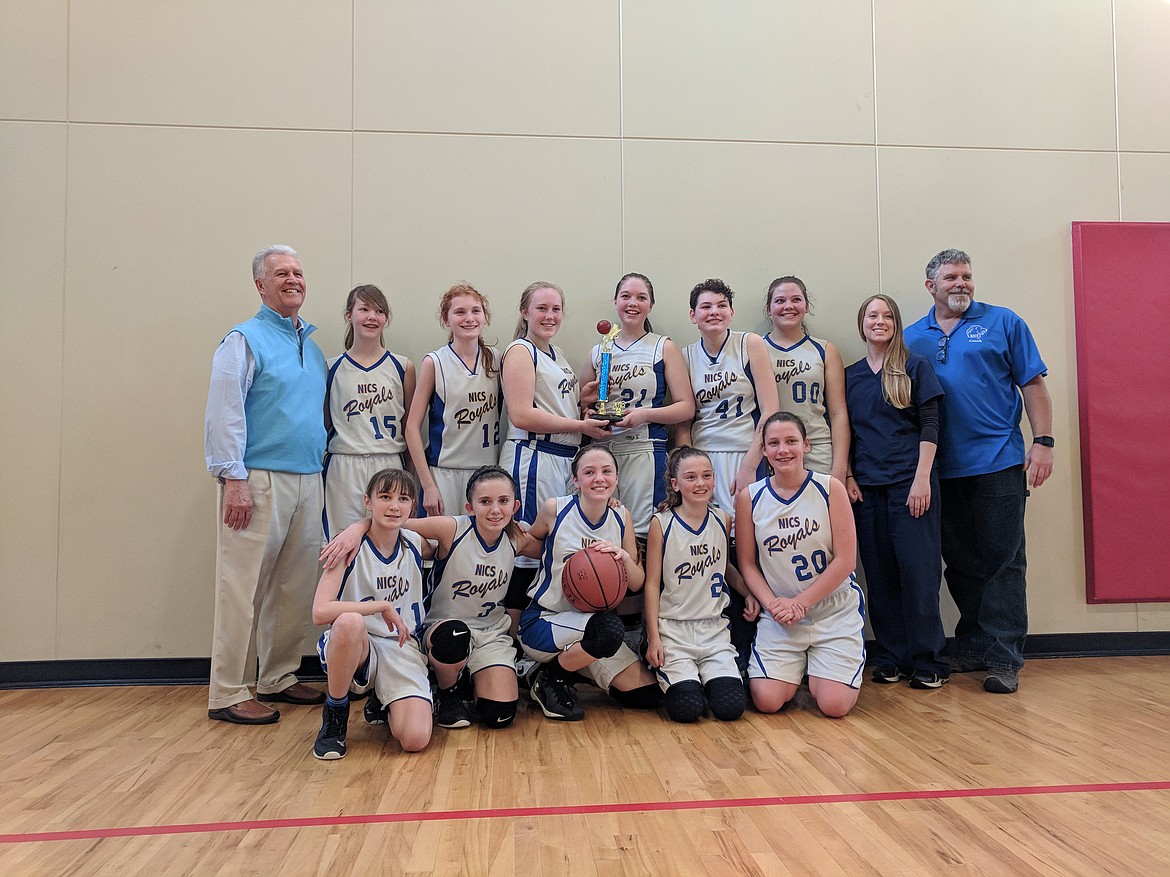 Courtesy photo
North Idaho Christian School&#146;s middle school girls basketball team won both the Mountain Christian League title and league tournament with a record of 18-0. In the front row from left are Danica Kelly, Belle Schmitz, Alli Whiteman, Jennifer Peterson and Simone Pilgrim; and back row from left, coach Jerry Bittner, Heidi Williams, Lynsey Overturf, Amber Aittama, Trinity Knight, Rylee Overturf, Katie Weed, coach Kylie Andrews and coach Mike Anderson. Not pictured is Hailey Jo Parks. This is the fourth year in a row the NICS middle school girls have won both the league and tournament with an overall four-year record of 69-1.