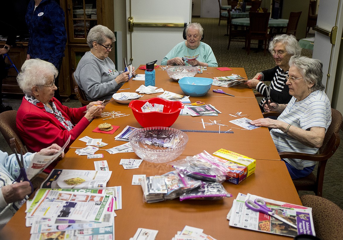 LOREN BENOIT/Press
From left, Phillis Anderson, Betty Peters, Jean Ingle, Corinne MacDonald and Helen Weddle cut coupons Tuesday morning at Legends Park Assisted Living in Coeur d&#146;Alene. The group has clipped $174,419 worth of coupons in the past year.