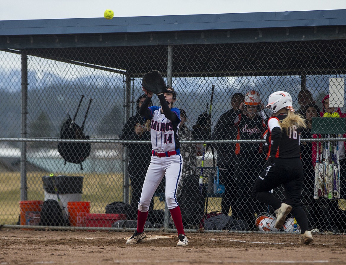 Coeur d&#146;Alene&#146;s Rebekah West 
catches a throw at first base for an out against West Valley.