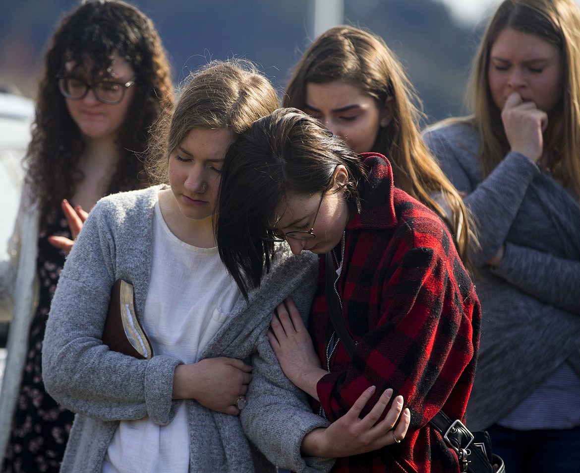 LOREN BENOIT/Press
Coeur d&#146;Alene High School junior Hannah Owens, left, and Nadia Luhring comfort each other Friday during an hour of prayer for Coeur d&#146;Alene High School principal Troy Schueller, who died Wednesday from a self-inflicted injury.