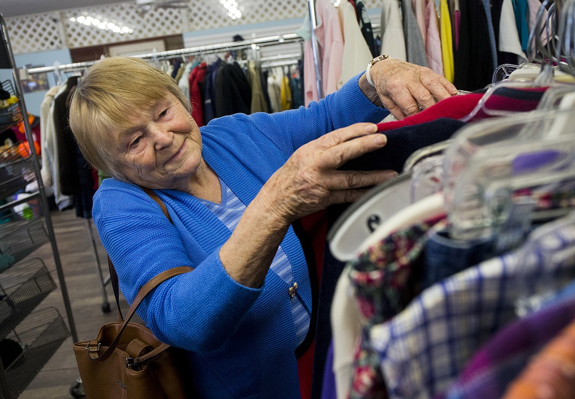 Renate Libey shops for clothes Wednesday afternoon at the Post Falls Senior Center Thrift Store. The thrift store is closing its doors March 31. &quot;I will miss the thrift store a lot,&quot; said Libey. &quot;I come down here to shop and usually end up finding something nice.&quot; (LOREN BENOIT/Press)