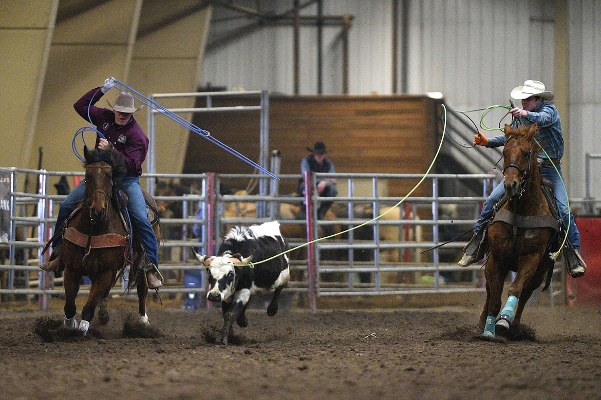 Brady Boyce, left, and Logan Beattie compete in the team roping event at the Montana High School Rodeo Association 2018 at Majestic Valley Arena in Kalispell on Friday. (Casey Kreider/Daily Inter Lake)