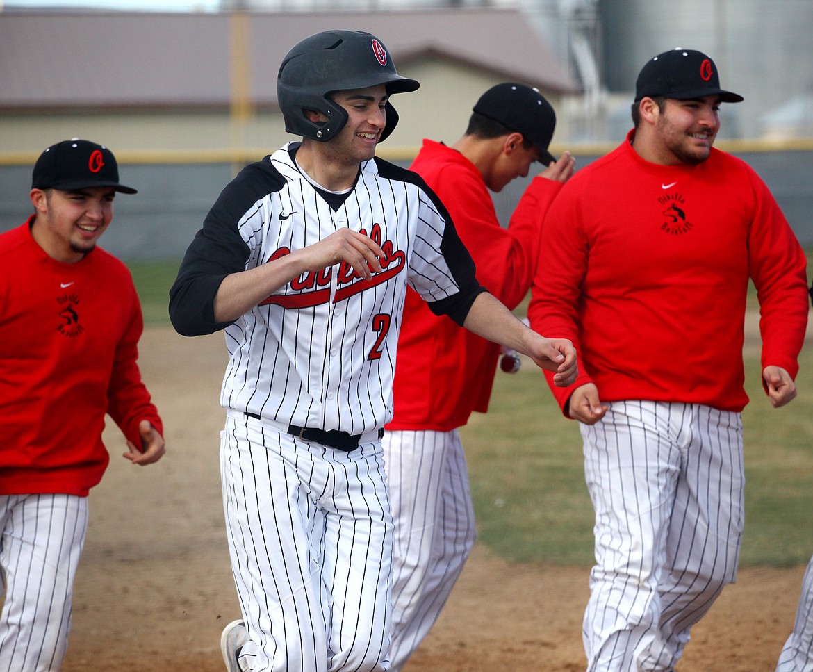 Rodney Harwood/Columbia Basin HeraldJonathan Garza II (2) is all smiles after hitting a home run in the late game of Saturday's CWAC doubleheader in Quincy.