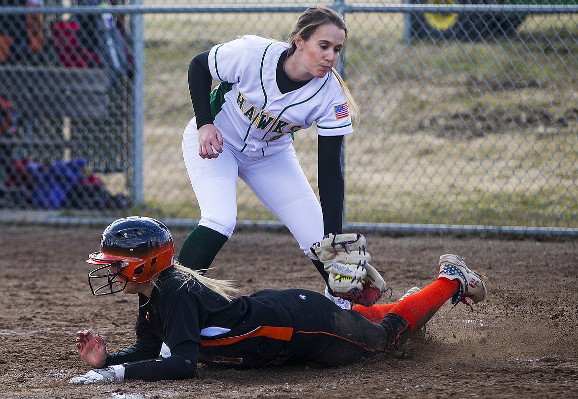 LOREN BENOIT/Press
Kelsey Horn of Post Falls High slides safely under Taylor Woolley&#146;s tag for a score during Tuesday&#146;s game at Lakeland High School.