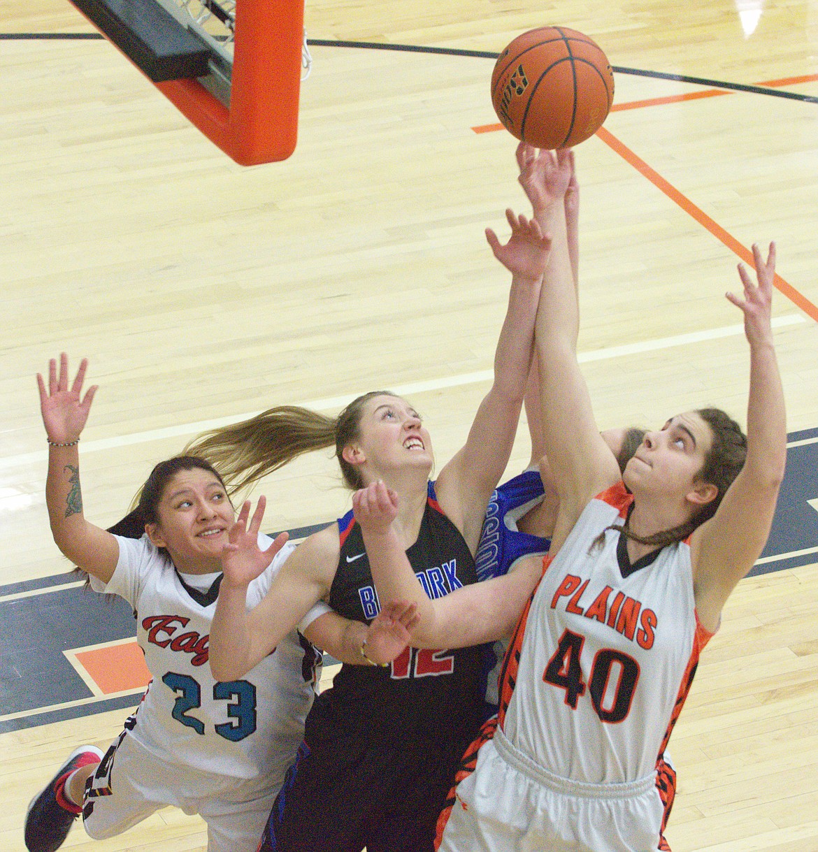 PLAINS BASKETBALL player Kira Altmiller (far right) crashes the boards with Mission High School&#146;s Leila Marsh (right), Jaime Berg (middle) and Kyra Aimsback (left) at the Mission Mountain All-Star game Thursday night at the Ronan Events Center. (Jason Blasco/Lake County Leader)