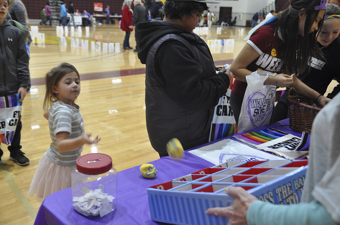 AMELIA LIES, 5, of Polson, takes her turn at a game at the Lake County Relay for Life Friday, March 23. (Ashley Fox/Lake County Leader)