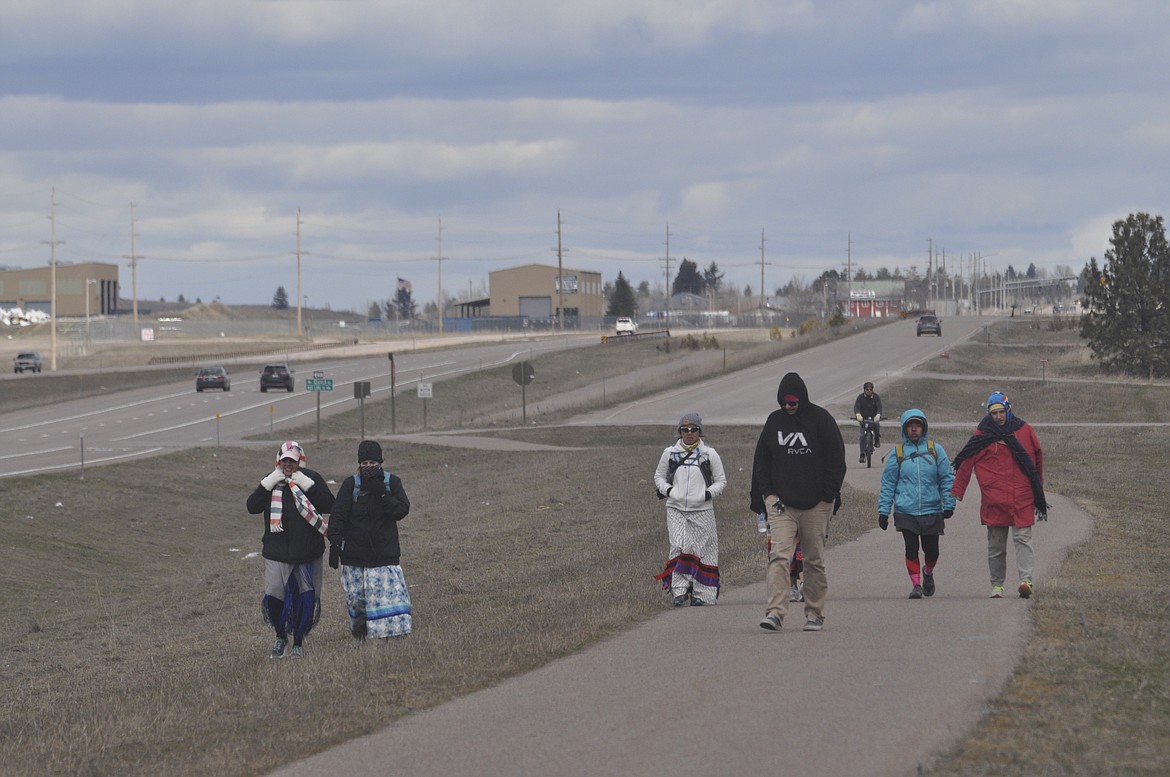 A CORE GROUP of eight people walk along U.S. Highway 93 Monday for the second annual Walk to Honor Missing and Murdered Indigenous Women. (Ashley Fox/Lake County Leader)