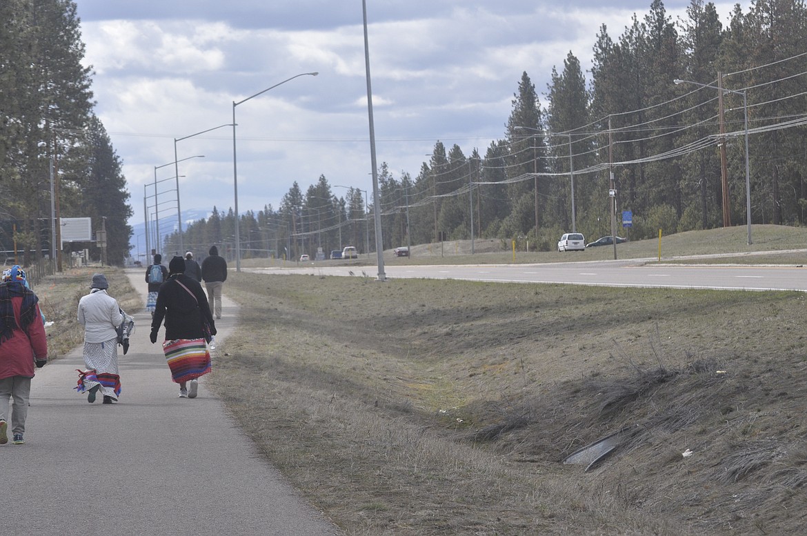 DRESSED IN REGALIA, a group of people walk along U.S. Highway 93 in an effort to raise awareness of missing and murdered indigenous women. (Ashley Fox/Lake County Leader)