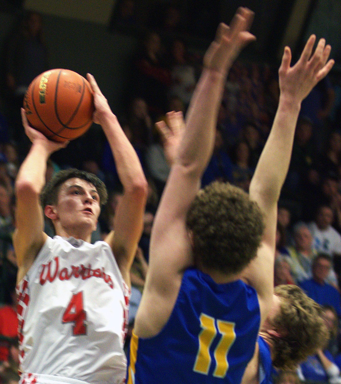 ARLEE WARRIORS point guard Phillip Malatare shoots over a Scobey defender in the semifinal against Scobey at the Butte Civic. Malatate didn&#146;t lose very many basketball during his illustrious high school career. (photo by Jason Blasco/Lake County Leader)