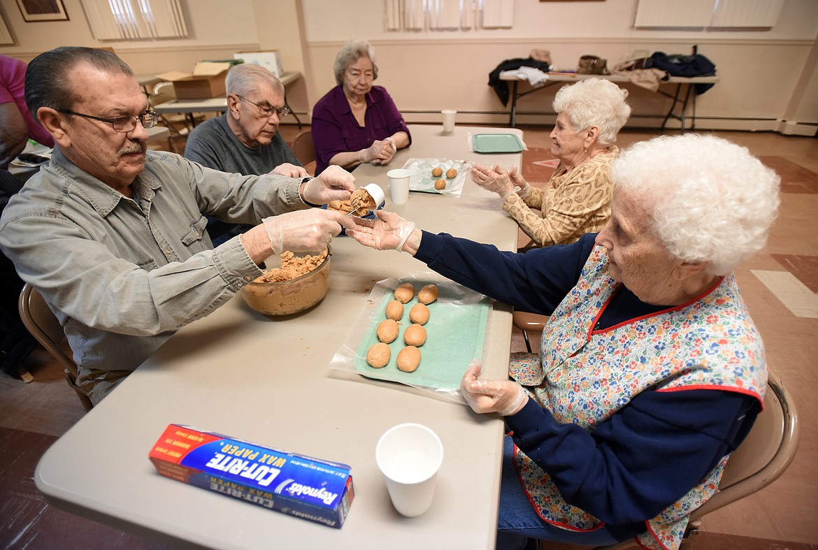 A group of volunteers measures and shapes the special Easter eggs.