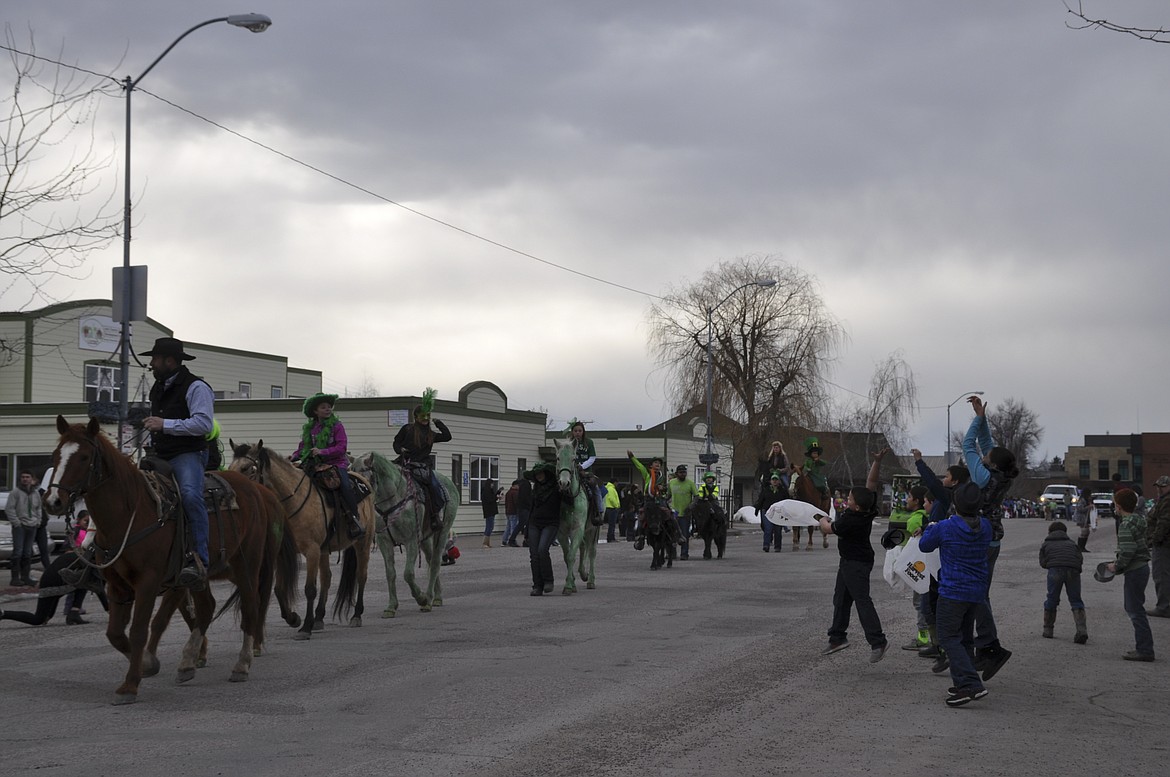 CHILDREN JUMP in hopes of catching candy from participants at the 29th Annual O&#146;Ronan&#146;s St. Patrick&#146;s Day Parade on Saturday, March 17. (Ashley Fox/Lake County Leader)