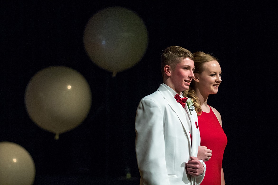 Libby freshman Jay Beagle and senior Laurynn Lauer stop and pose for photos during the Grand March at Libby Prom on Saturday, March 17, 2018. (John Blodgett/The Western News)