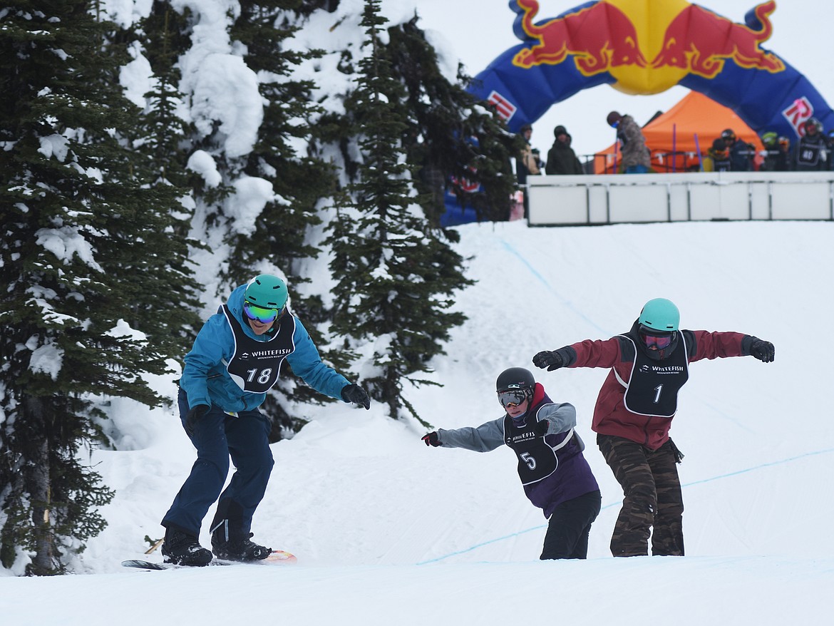 Top, a trio of snowboarders get going during the boardercross portion of the Nate Chute Banked Slalom and Boardercross competition last weekend at Whitefish Mountain Resort. Right, a snowboarder leans into his turn during the event.