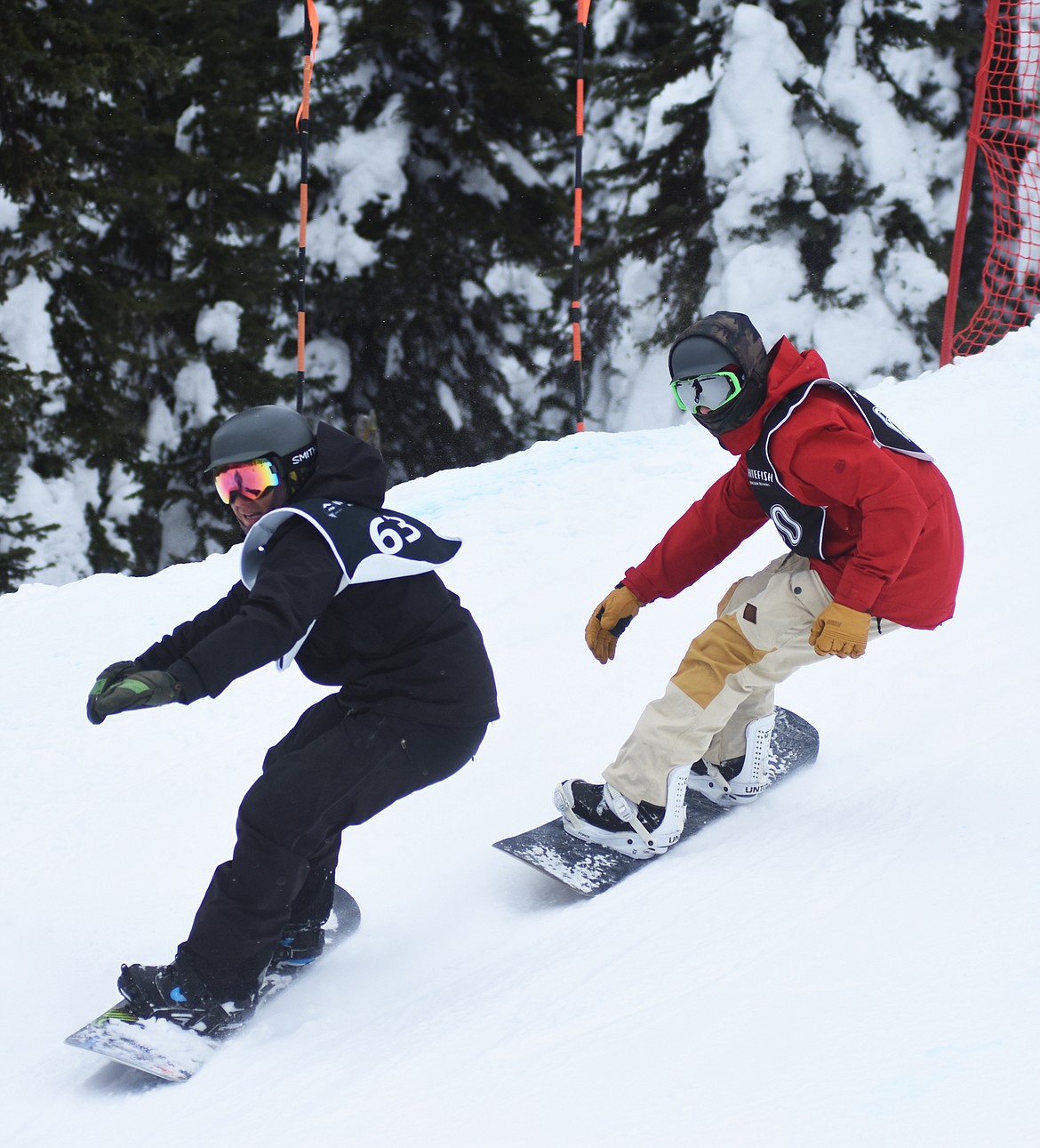 Two snowboarders, neck-in-neck, round a turn at the Nate Chute Banked Slalom and Boardercross competition last weekend at Whitefish Mountain Resort.