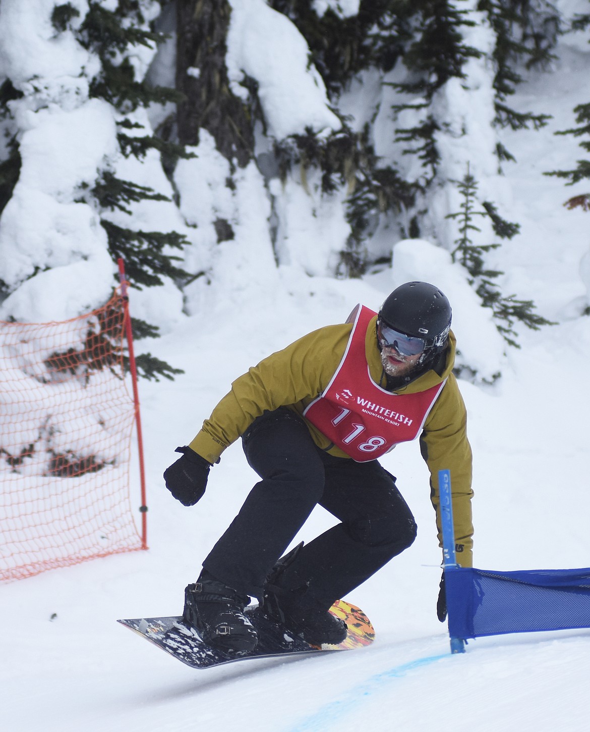 A snowboarder leans into his turn during the Nate Chute Banked Slalom and Boardercross competition last weekend at Whitefish Mountain Resort.