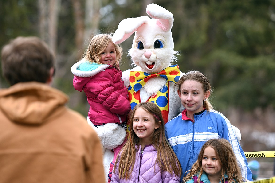 Children have their picture taken with the Easter bunny at the 6th annual Flathead Shelter Friends Easter Egg Hunt at Woodland Park on Saturday in Kalispell. (Casey Kreider/Daily Inter Lake)