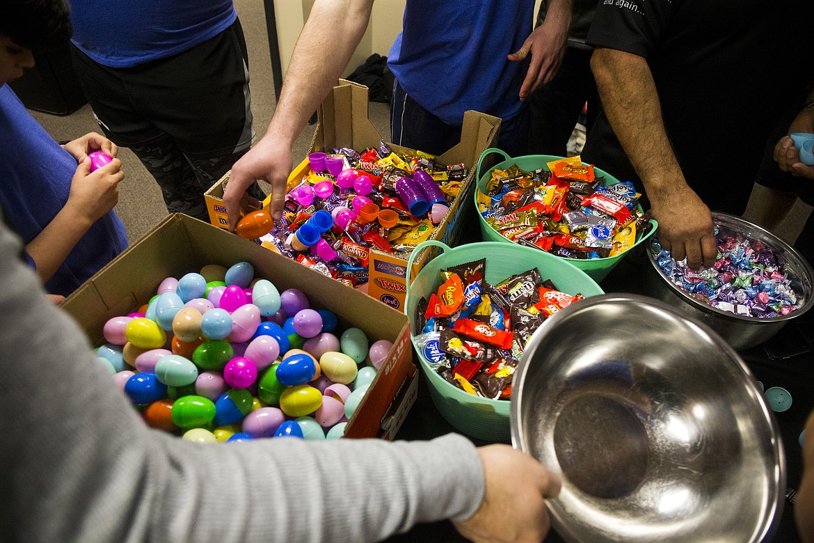 North Idaho Men's Rugby Club players stuff around 7,000 eggs in preparation for Sunday's Easter egg hunt. The Easter egg hunt will be at Coeur d'Alene City Park at 1 p.m. on Sunday. (LOREN BENOIT/Press)