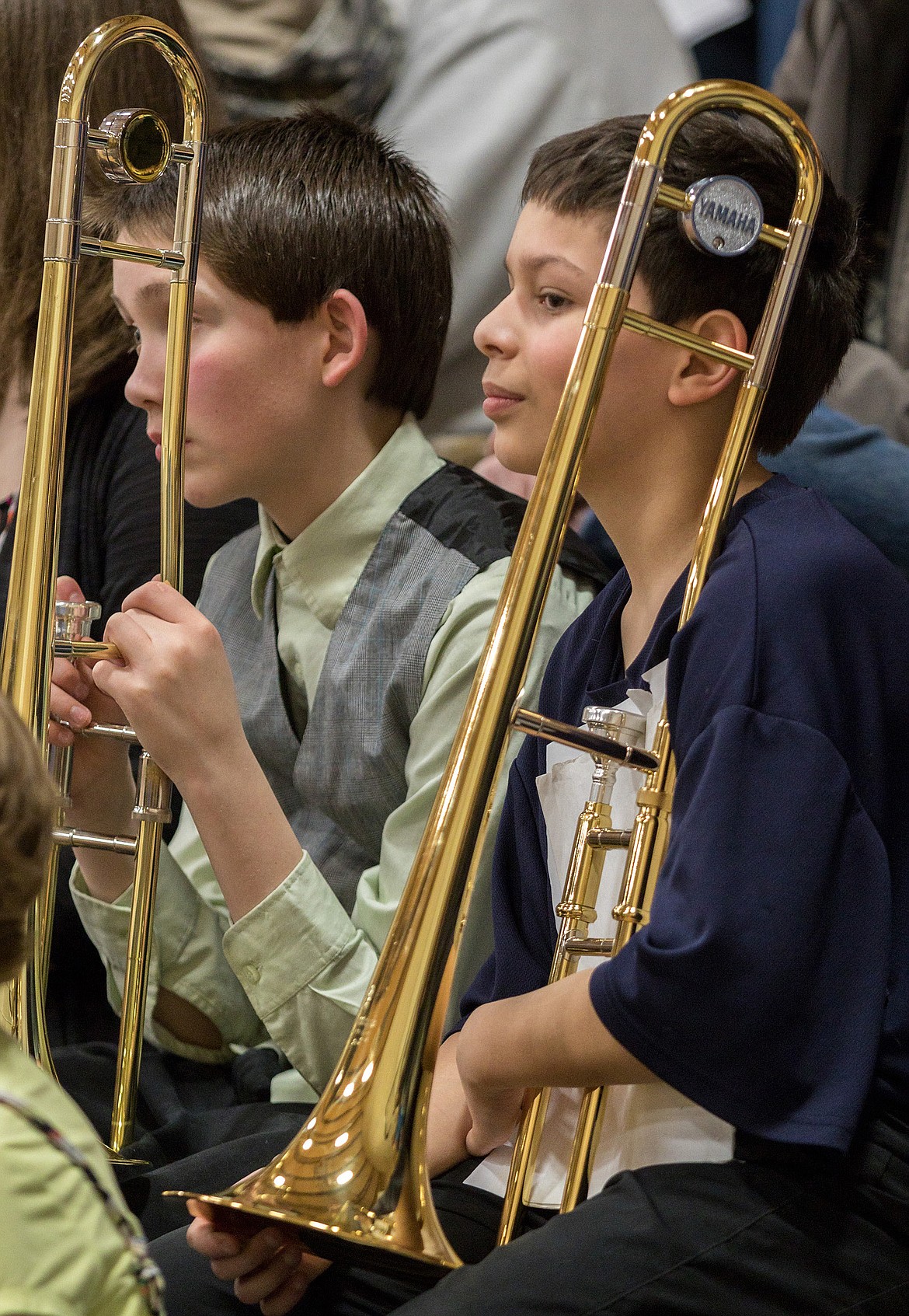 Libby sixth graders Zach Leary, left, and Jason Quintanilla sit with their trombones while waiting to perform in the Libby Elementary School gym on Tuesday, March 27, 2018. (John Blodgett/The Western News)