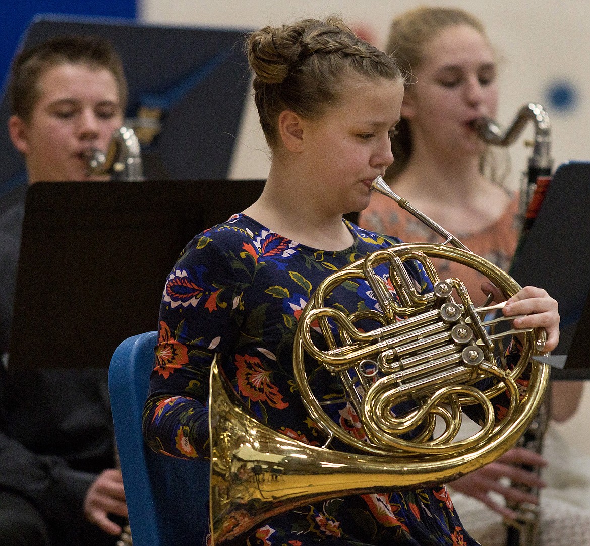Zane Nordwick, left, Hannah Carlisle, foreground, and Ember Rode perform in the combined sixth- and eighth-grade bands during a concert in the Libby Elementary School gym on Tuesday, March 27, 2018. (John Blodgett/The Western News)