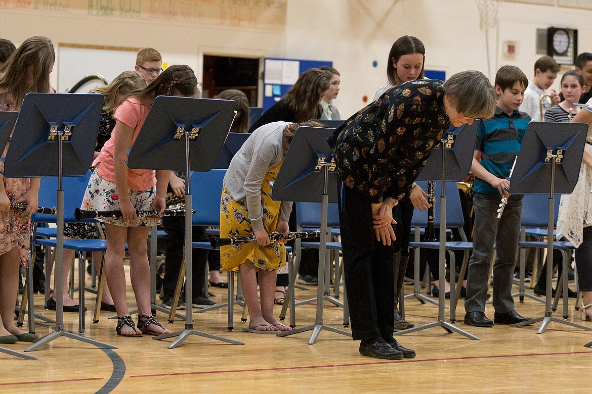 Band Director Brenda Nagode, foreground, and the sixth grade band take a bow after performing during a concert in the Libby Elementary School gym on Tuesday, March 27, 2018. (John Blodgett/The Western News)