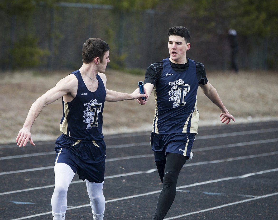 Timberlake&#146;s Kyle Lightner hands off the baton to Jordan Hardy in the 4x200-meter relay Friday evening at the Kootenai County Challenge.